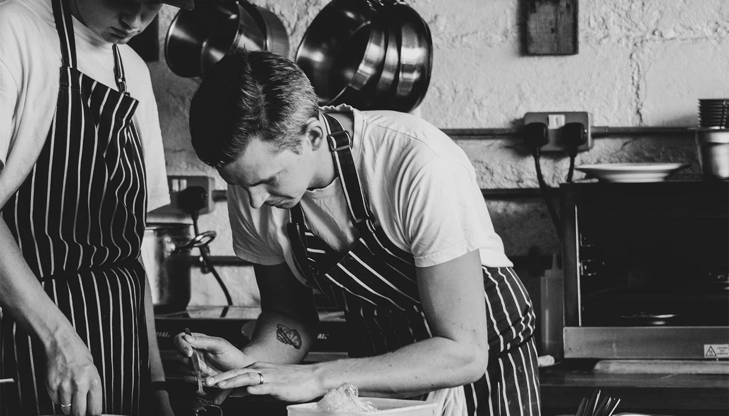 Two Chefs preparing food in a kitchen