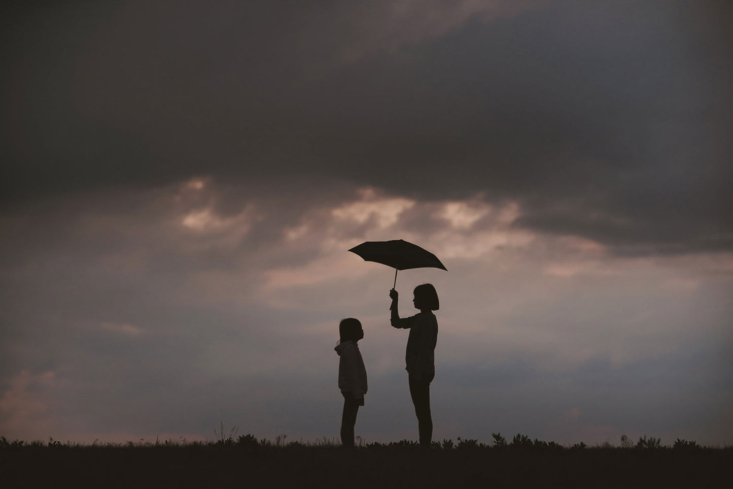 sisters with an umbrella